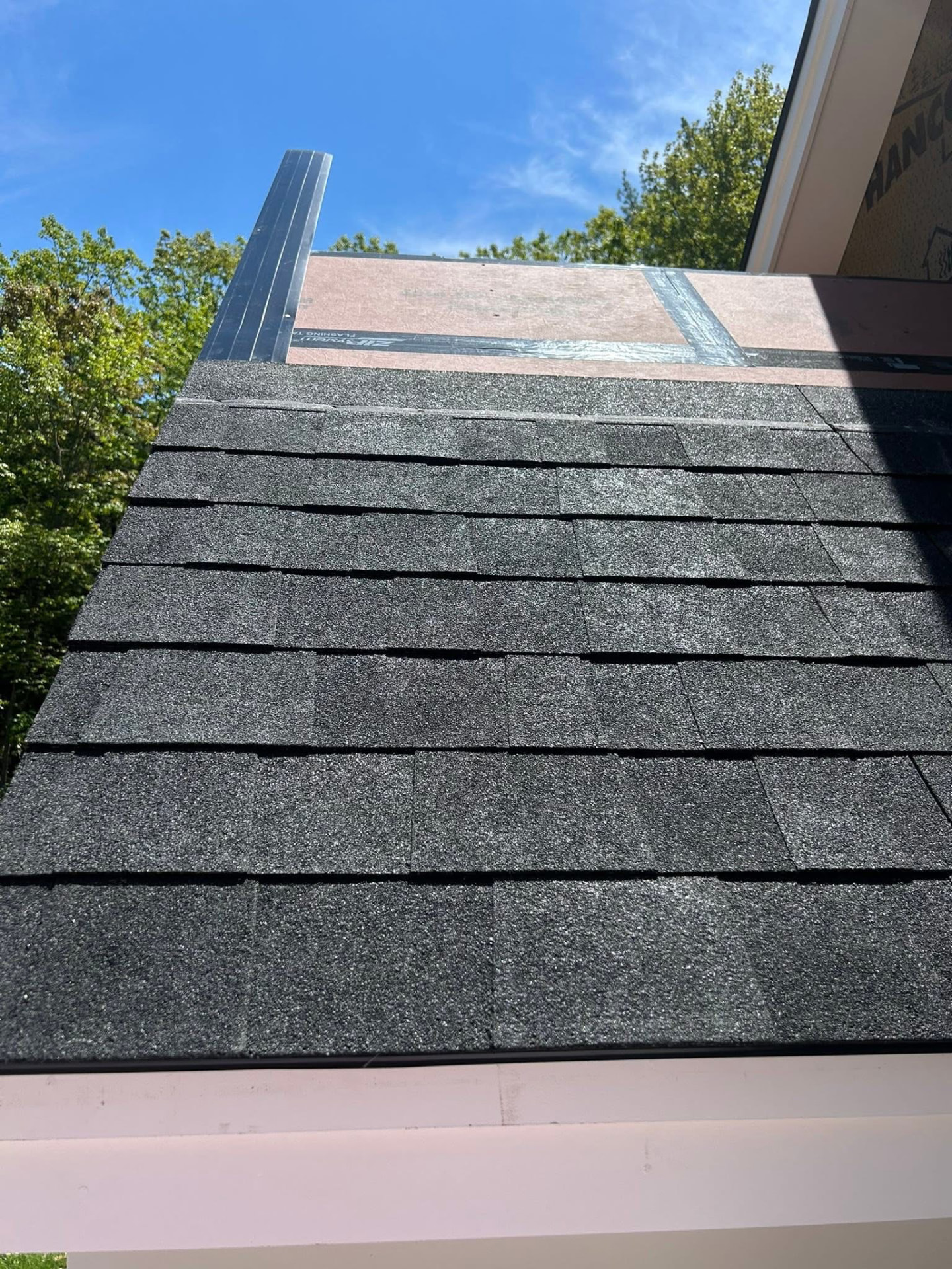 New architectural asphalt shingle roofing installed on a home