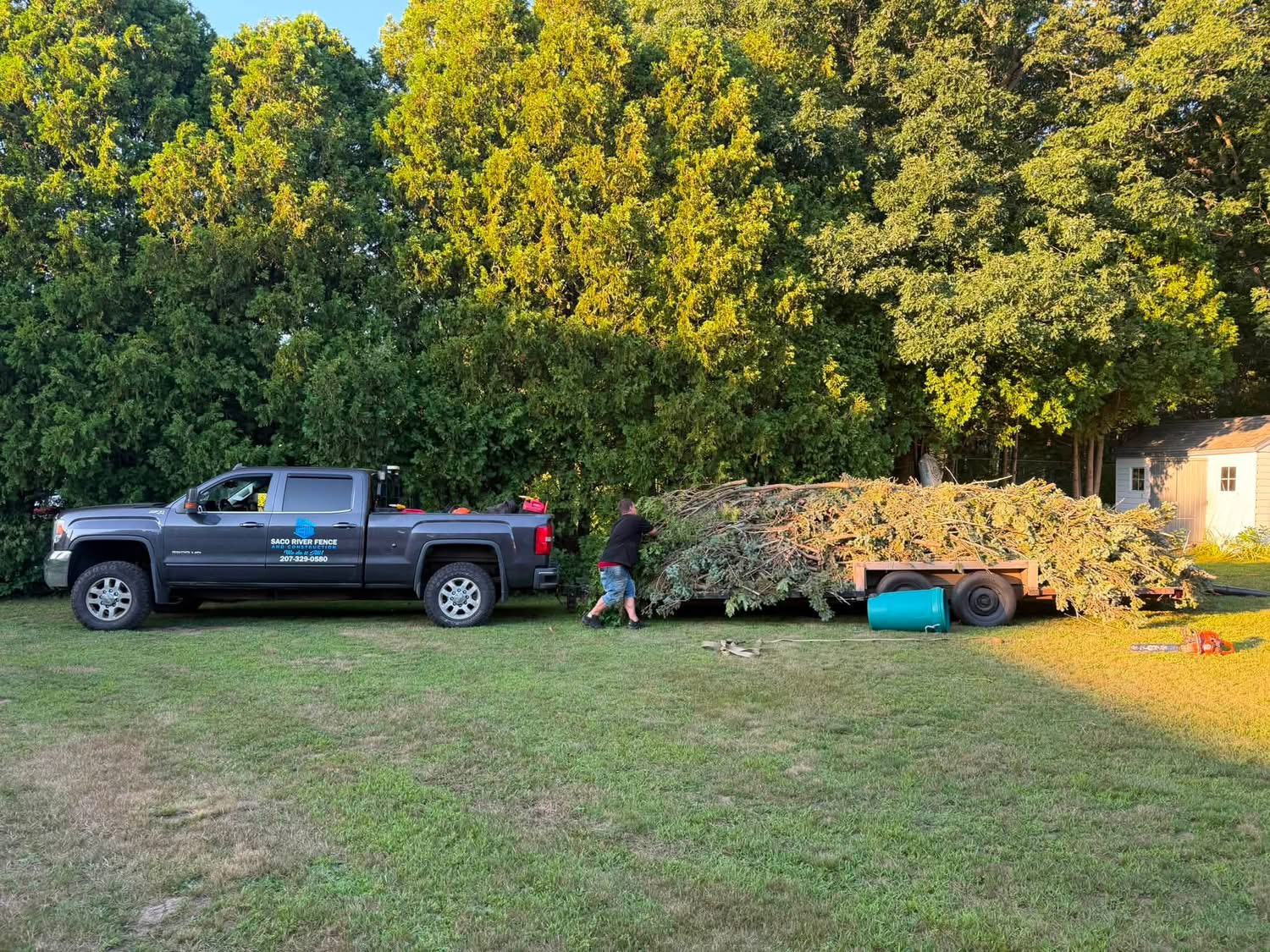 Crew loading brush onto a trailer after tree and property clearing