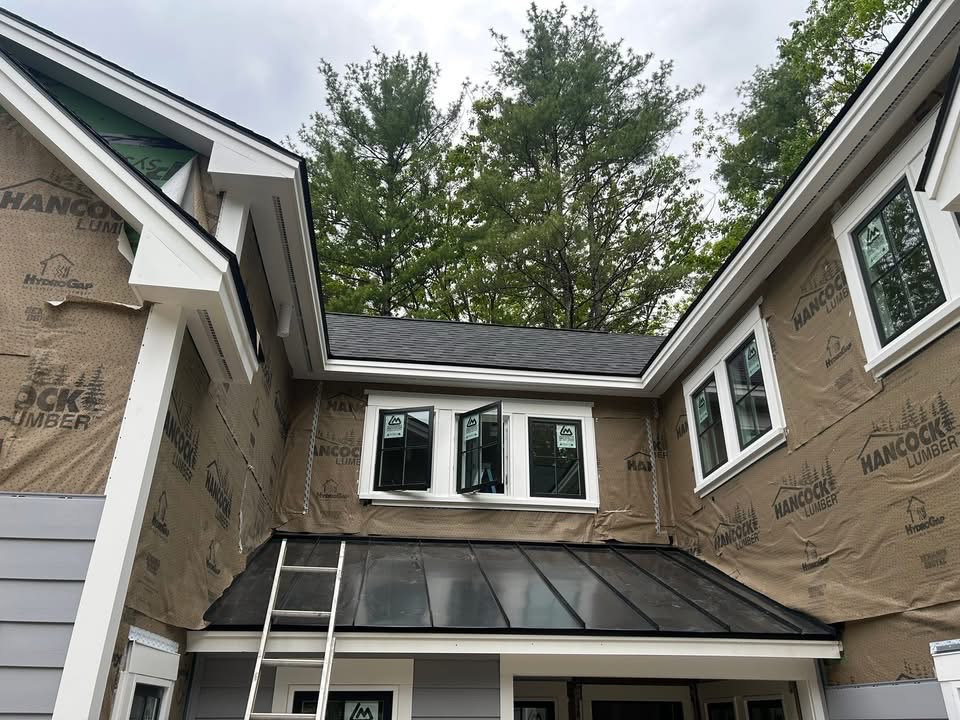 Roofing and siding work in progress on a new home addition