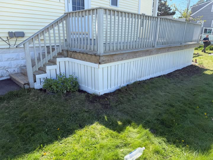 Deck with new white board-and-batten skirting and stairs